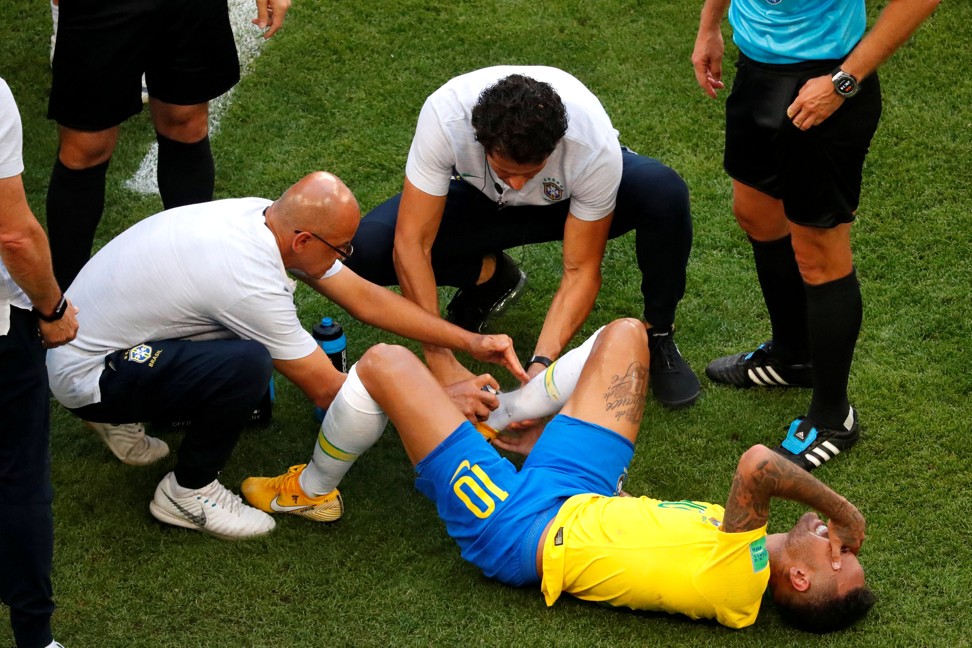 Neymar receives treatment from medical staff. Photo: Reuters