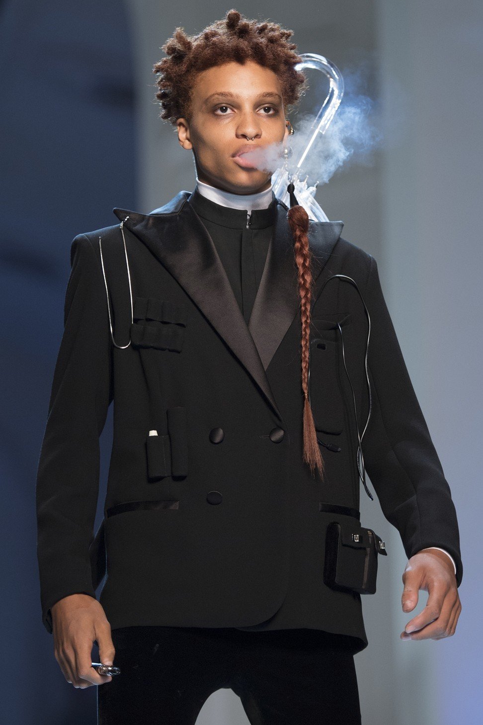 A model presents an avant-garde black outfit paired with a shisha as accessory. Photo: EPA
