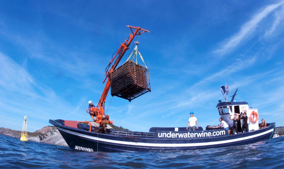 Part of Crusoe Treasure’s underwater cellar is loaded on a boat in Plentzia bay, near Bilbao in Spain. Photo: AFP
