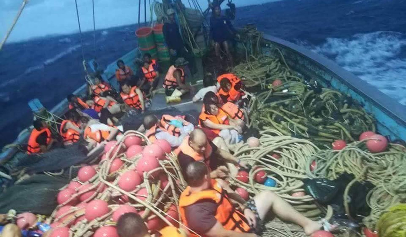 Rescued tourists huddle on the bow of a trawler that rescued them near the island of Phuket on Thursday. Photo: Xinhua