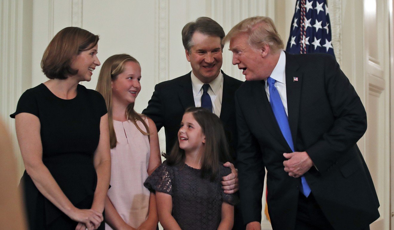 US President Donald Trump talks with Judge Brett Kavanaugh his Supreme Court nominee, and his family in the East Room of the White House. Photo: AP