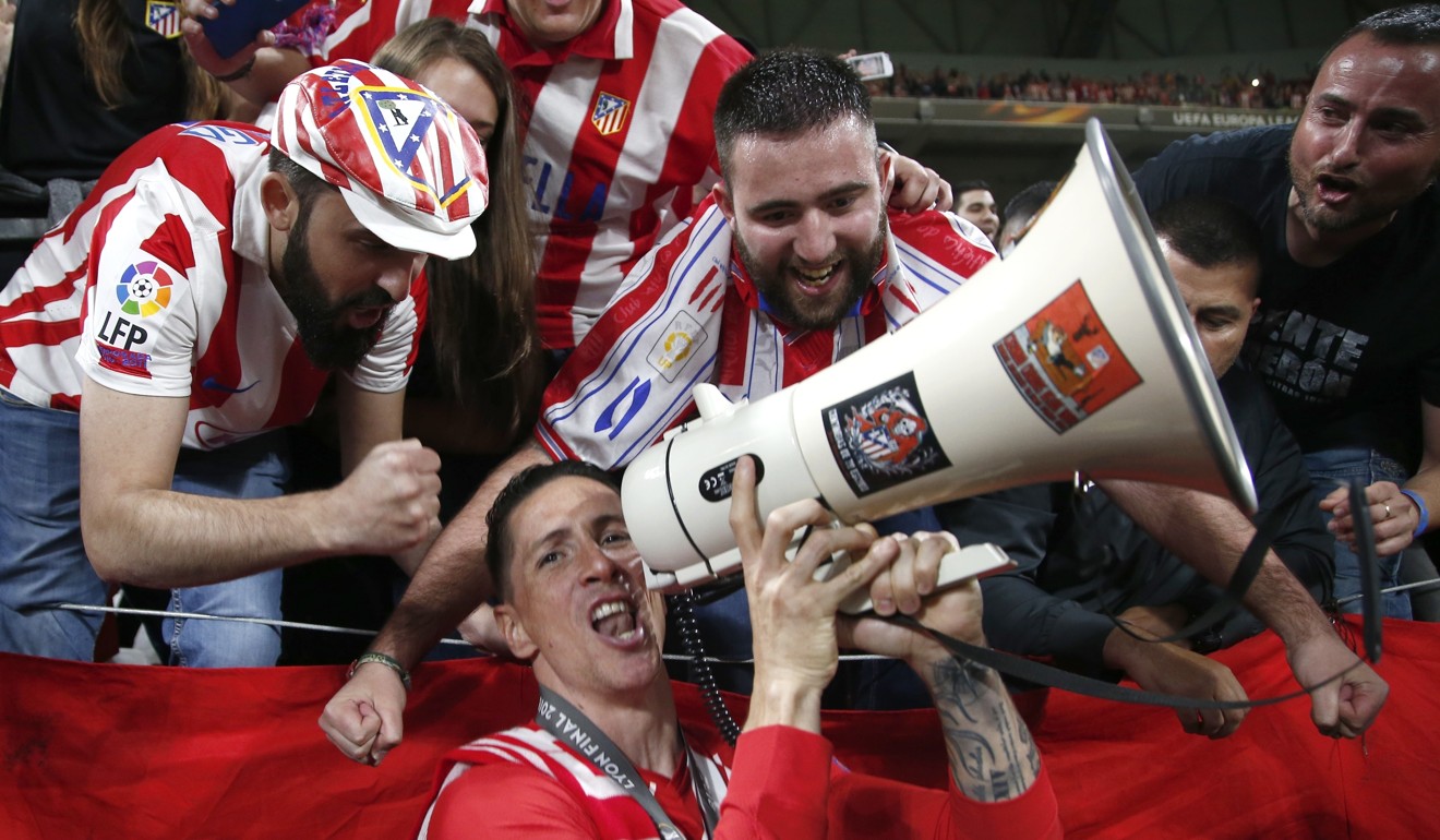 Fernando Torres celebrates with fans after winning the Europa League with Atletico. Photo: AP