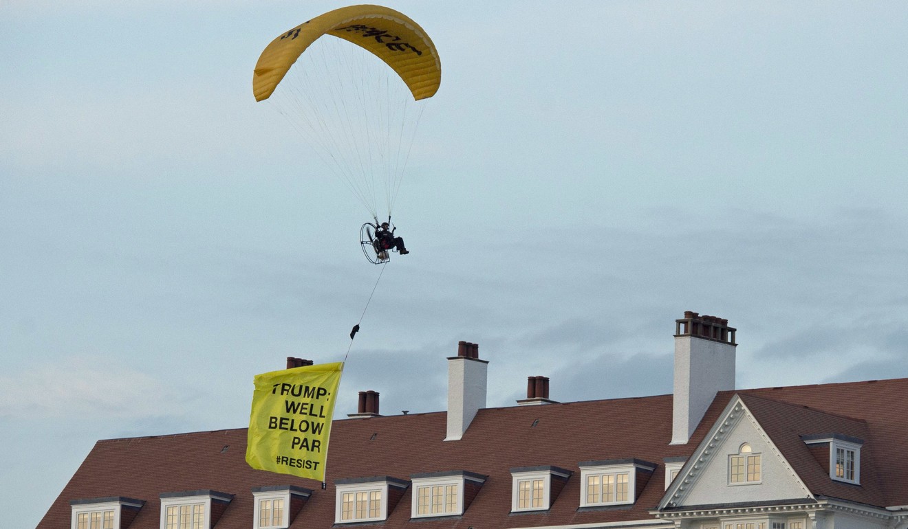 A Greenpeace protester flying a microlight passes over US President's Donald Trump's resort in Turnberry, South Ayrshire, Scotland with a banner reading “Trump: Well Below Par”, shortly after the US President arrived at the hotel on Friday. Photo: PA via AP