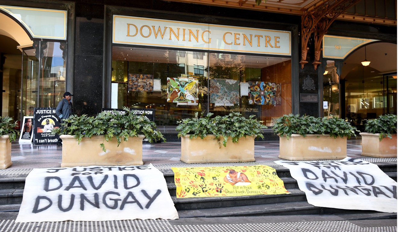 Banners outside Downing Centre Court in Sydney. Photo: EPA