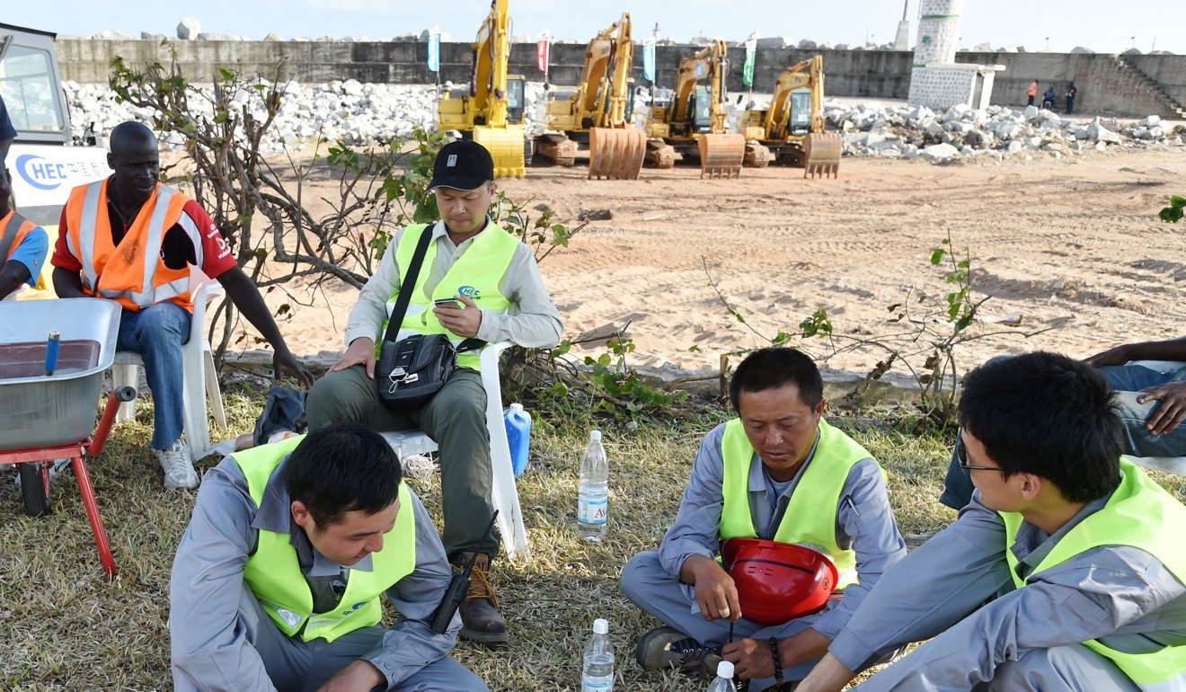 Chinese construction staff take a break while working on a project in Abidjan. Photo: AFP