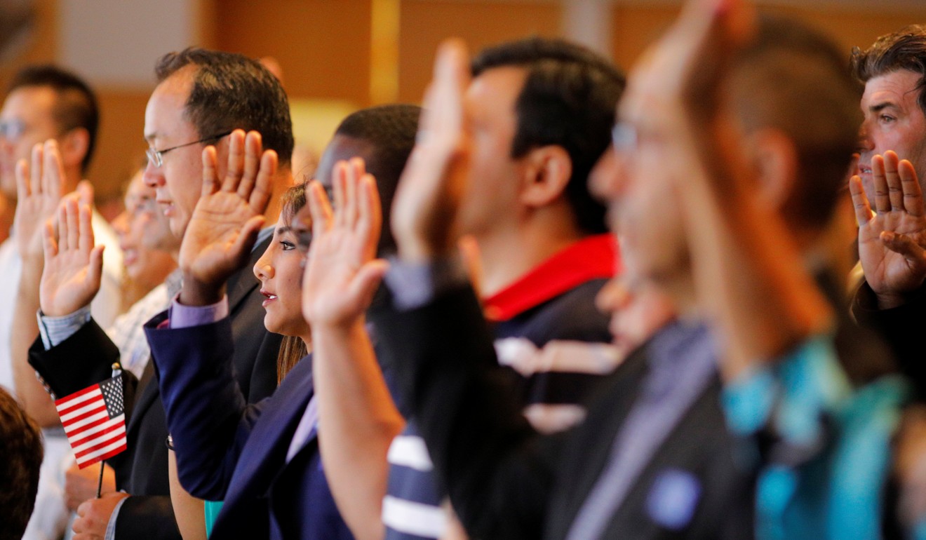 New US citizens take the oath during a ceremony at the John F. Kennedy Presidential Library in Boston, Massachusetts, on July 18. In the US, immigrants take out patents at 2-3 times the rate of native-born citizens, and their innovations benefit non-immigrants as well. Photo: Reuters