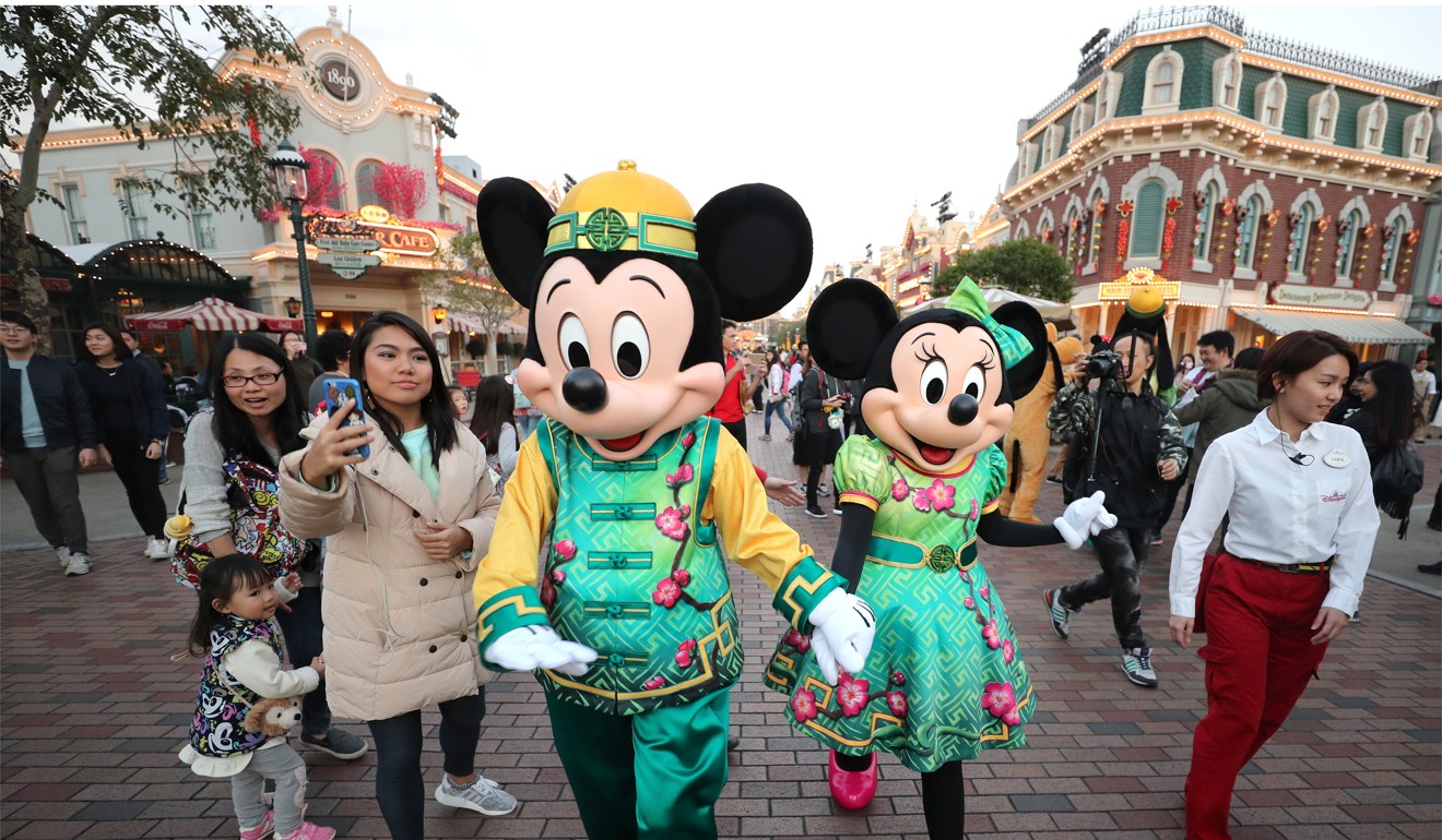 Mickey Mouse and Minnie Mouse dressed in festive clothes in celebration of the Lunar New Year at Hong Kong Disneyland on January 18. At least part of Disneyland could be redeveloped to make way for housing. Photo: Winson Wong