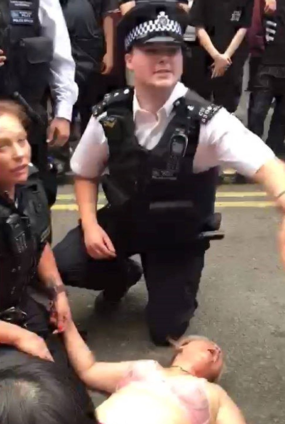 London police with a woman on Gerrard Street in Chinatown during a July 5 immigration raid. Photo: YouTube