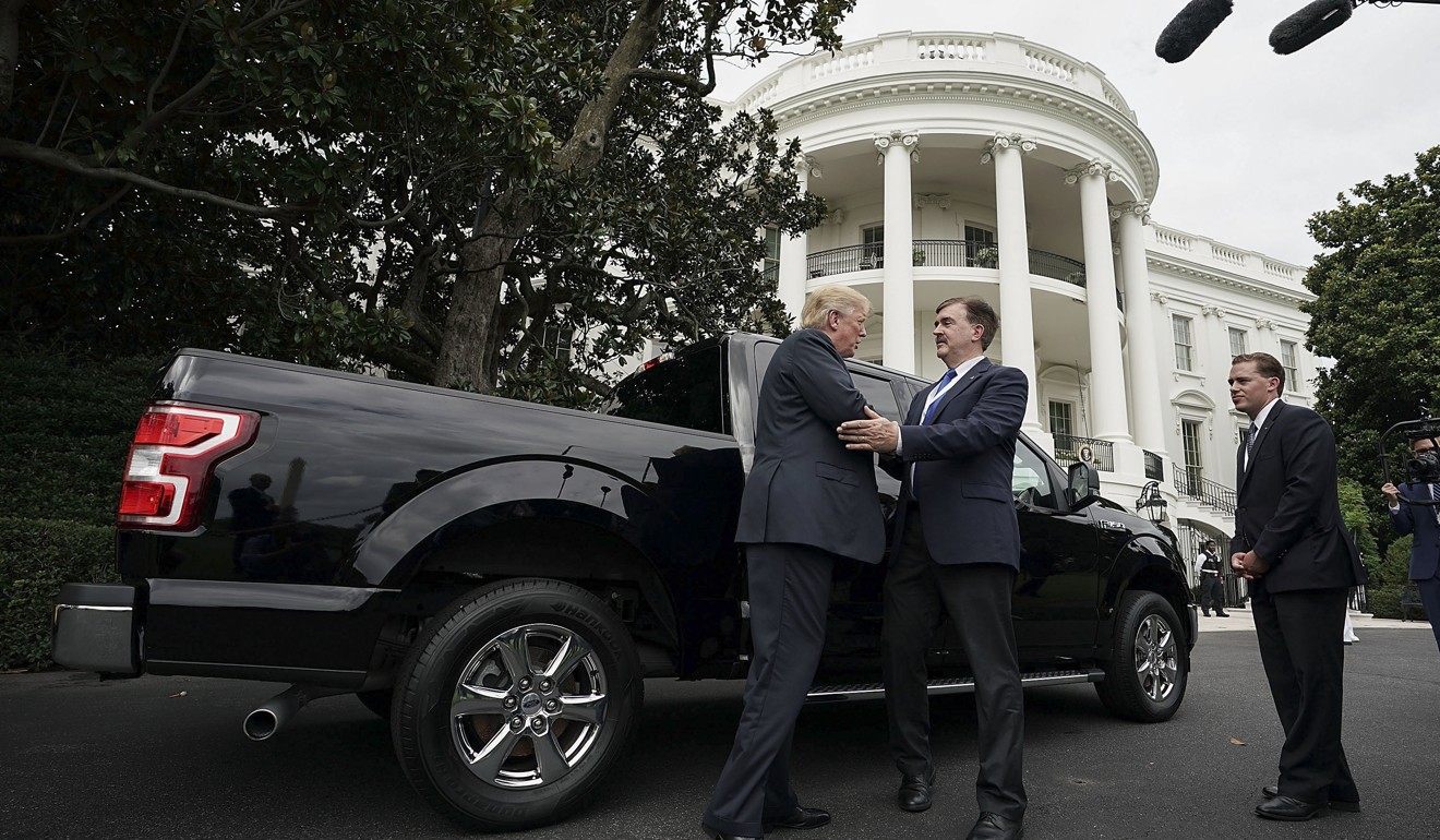 US President Donald Trump, left, talks to Curt Magleby, vice-president of government relations with Ford Motor Co, centre, next to a Ford F-150 truck at the White House. Photo: Bloomberg