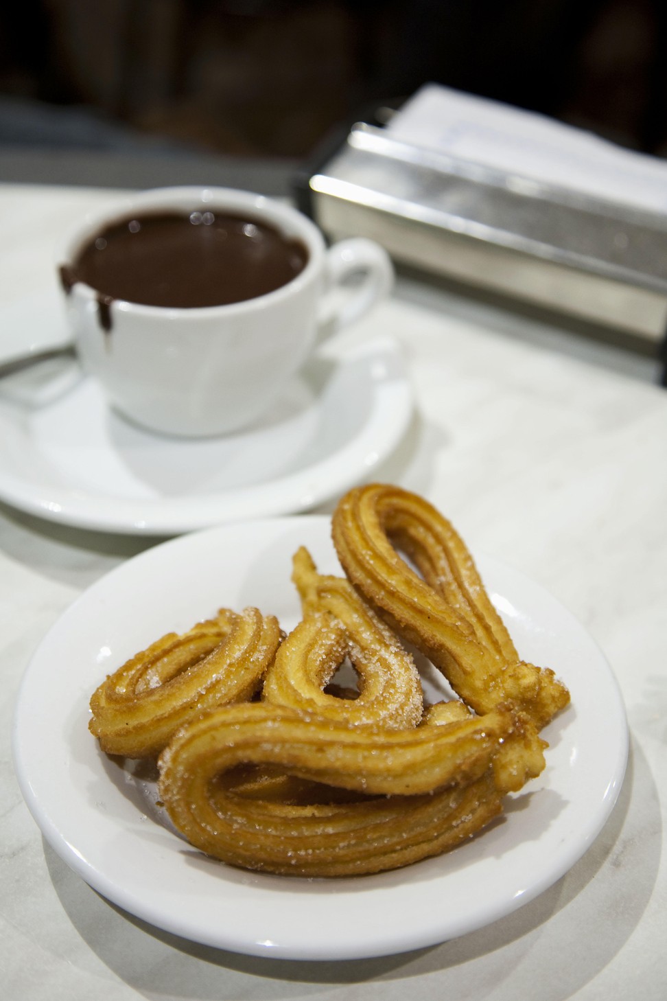 While in Barcelona, tuck into a hot chocolate and churros for first breakfast. Photo: Alamy