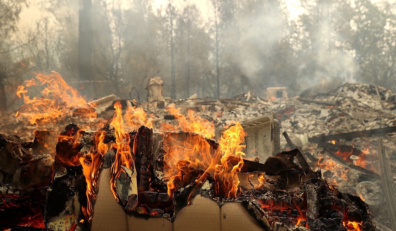 A home continues to burn after the Carr Fire moved through Redding, California, on Saturday. A Redding firefighter and bulldozer operator were killed battling the fast moving fire that has burned over 80,000 acres and destroyed hundreds of homes. Photo: Getty Images/AFP