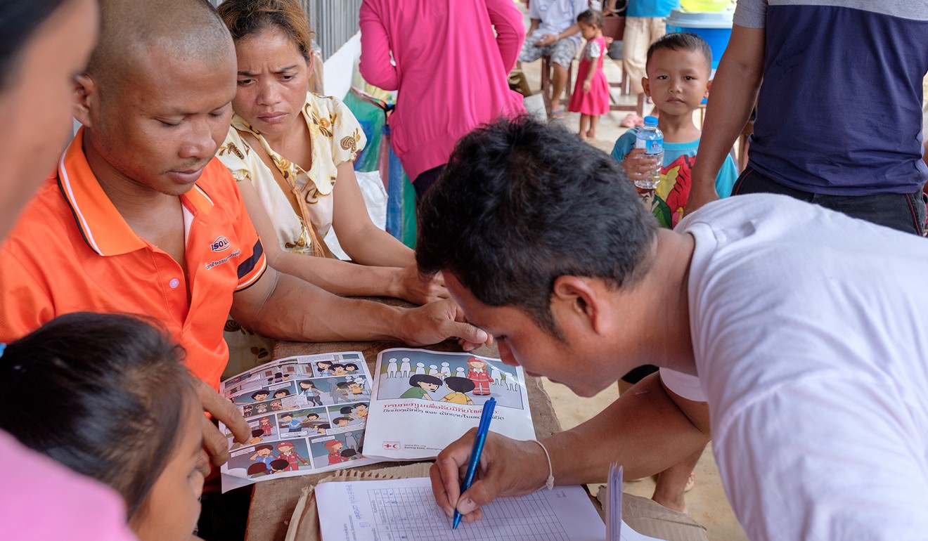 Villagers affected by the collapse of a dam in southeast Laos register at one of five rescue centres in Sanamxai district. Photo: Bart Verweij