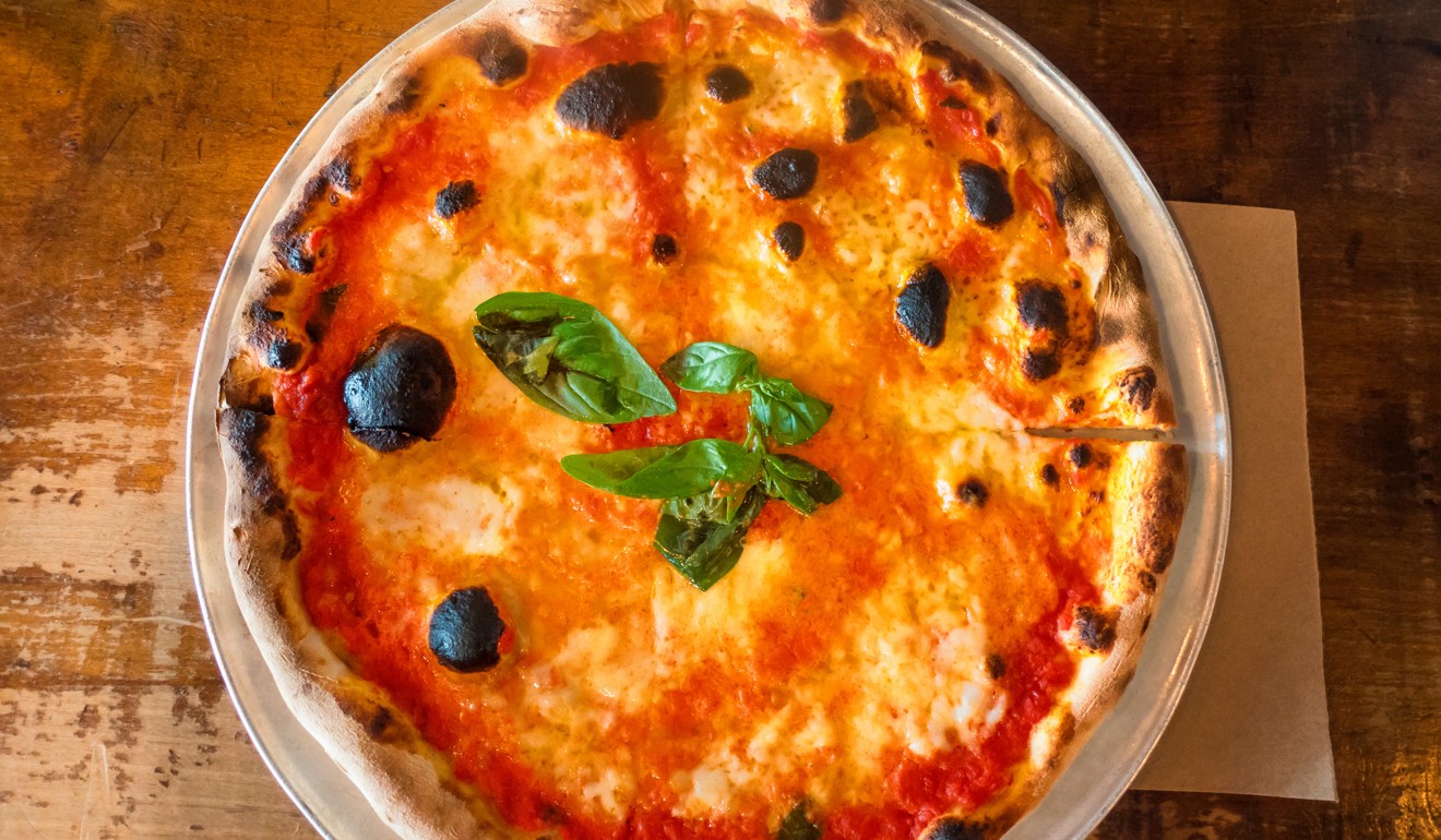 Pizza Margherita is a classic Neapolitan pizza, with mozzarella, tomato and basil copying the colours of the Italian flag. Photo: Alamy