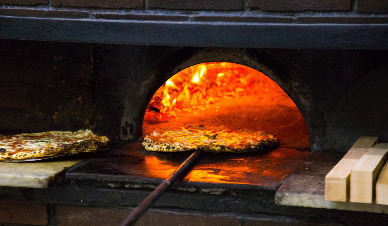 A traditional wood-fired pizza oven in Naples, Italy. Photo: Alamy