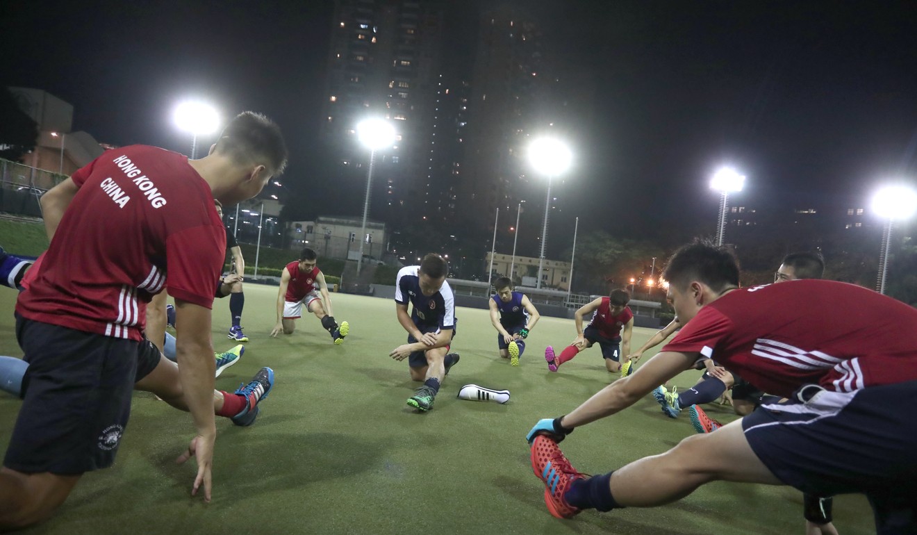 Hong Kong players perform stretches during training at King’s Park.