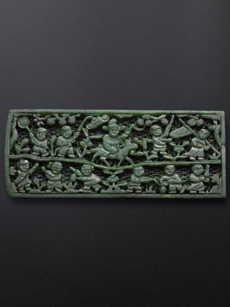The Chinese green jade belt plaque called ‘Moxiayu’, which depicts children playing a traditional ’groping for fish’ game