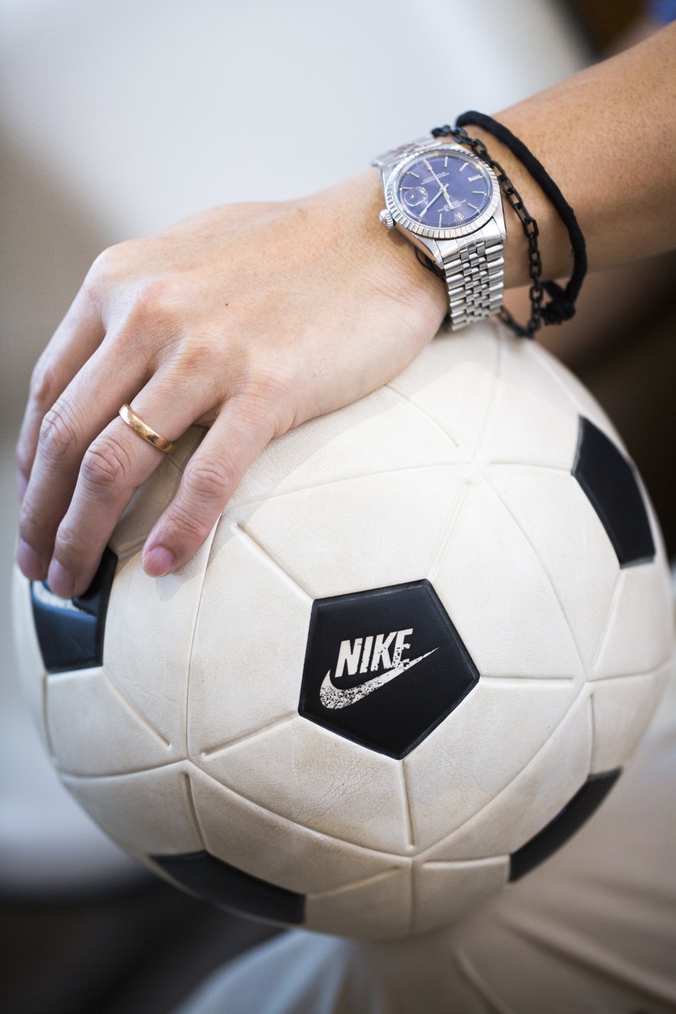 Lau’s vintage Rolex watch, and his Off-White x Nike soccer ball. Photo: Michelle Wong