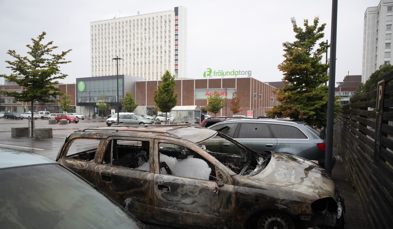 Burned out cars at Frolunda Square in Gothenburg. Photo: EPA