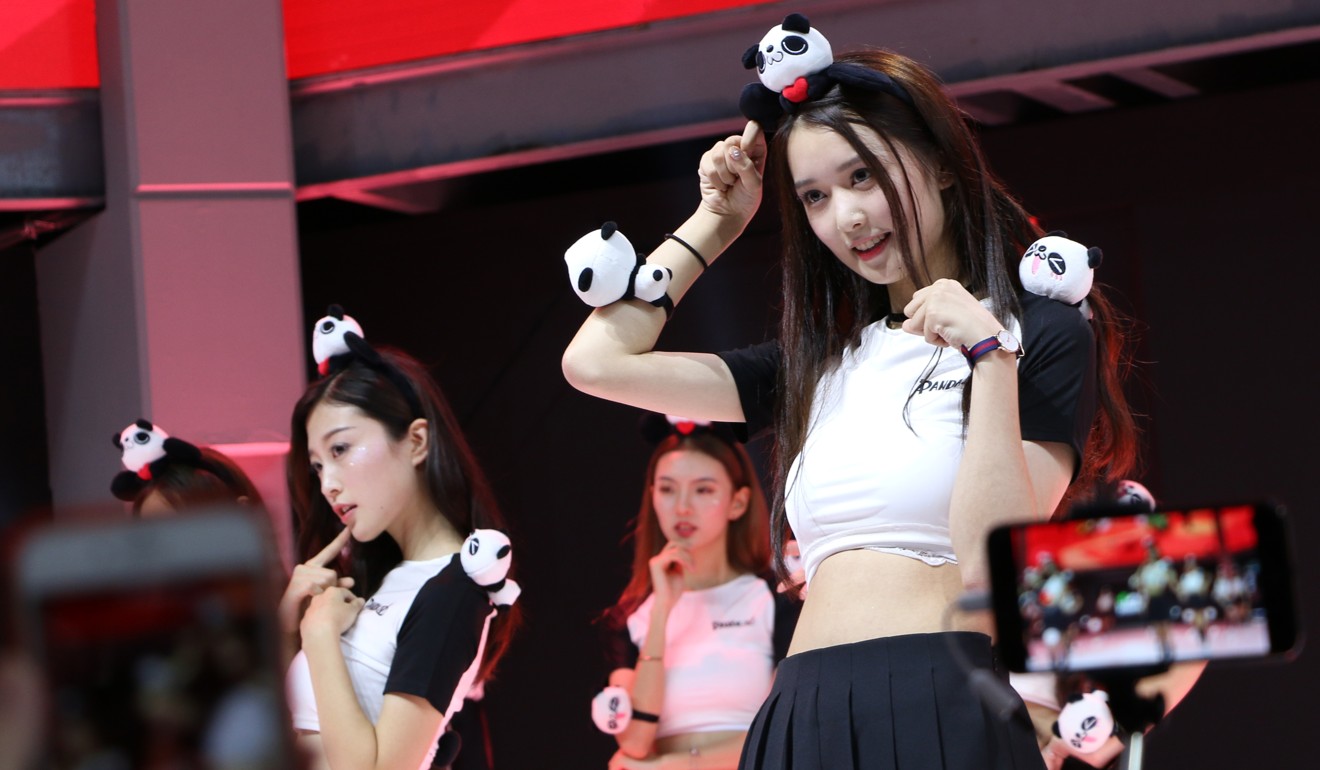 Attendees film showgirls at the Panda.TV demo at China’s biggest gaming show. Photo: Zheping Huang