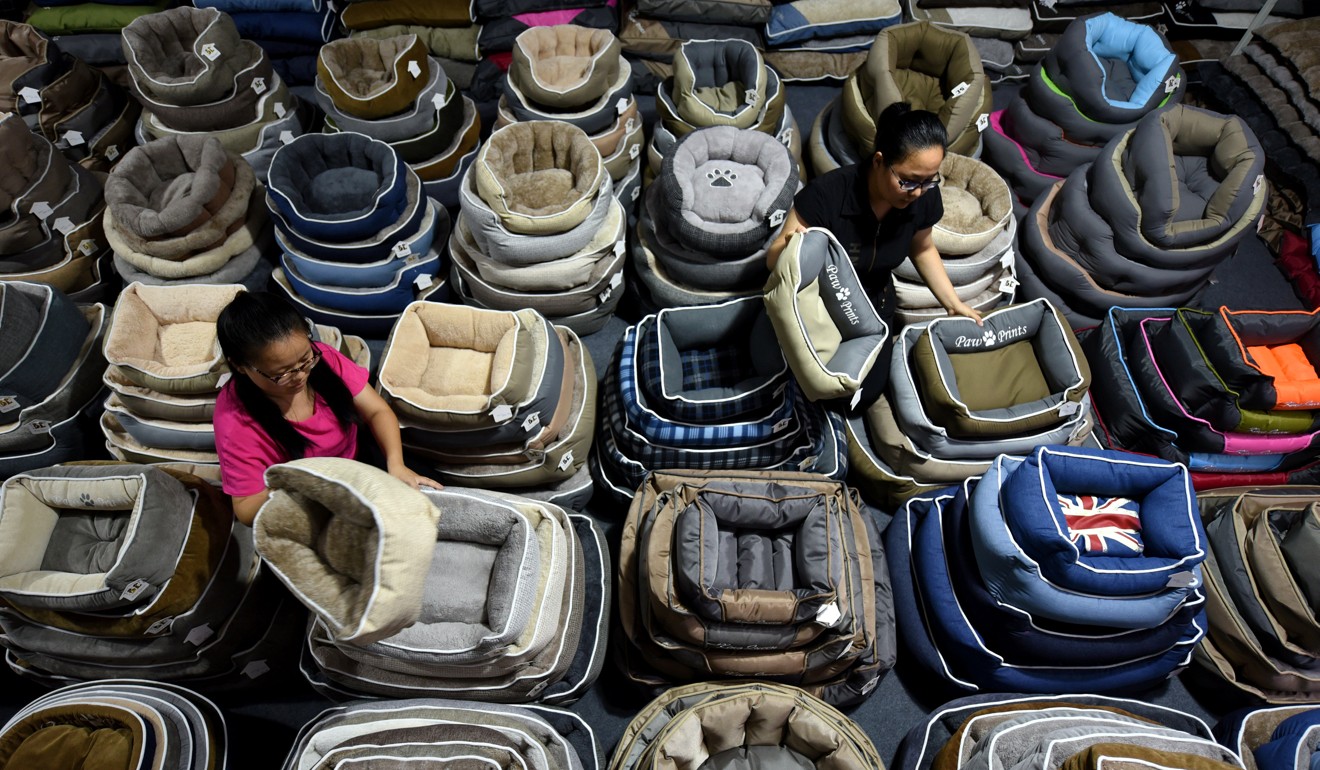 Workers sort dog beds for export in a factory in Linyi, Shandong province, China. Photo: Reuters 