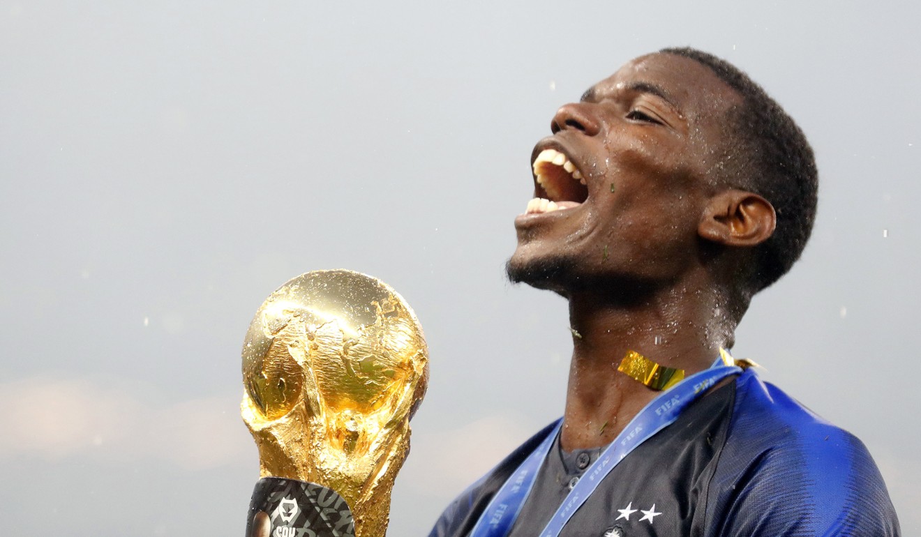 Paul Pogba celebrates with the World Cup trophy. Photo: Kyodo