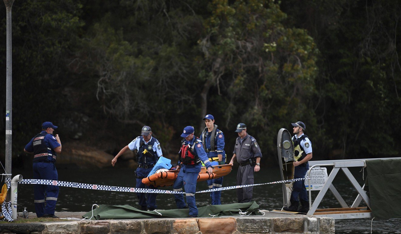 Emergency workers carry a body from the scene of the seaplane crash that killed British CEO Richard Cousins and family members on the Hawkesbury River, north of Sydney, on December 31, 2017. Photo: AP
