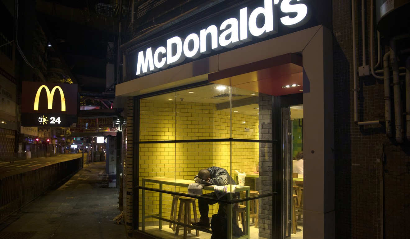 A McRefugees sleeps at a 24-hour McDonald's restaurant in Wan Chai. Photo: Sam Tsang