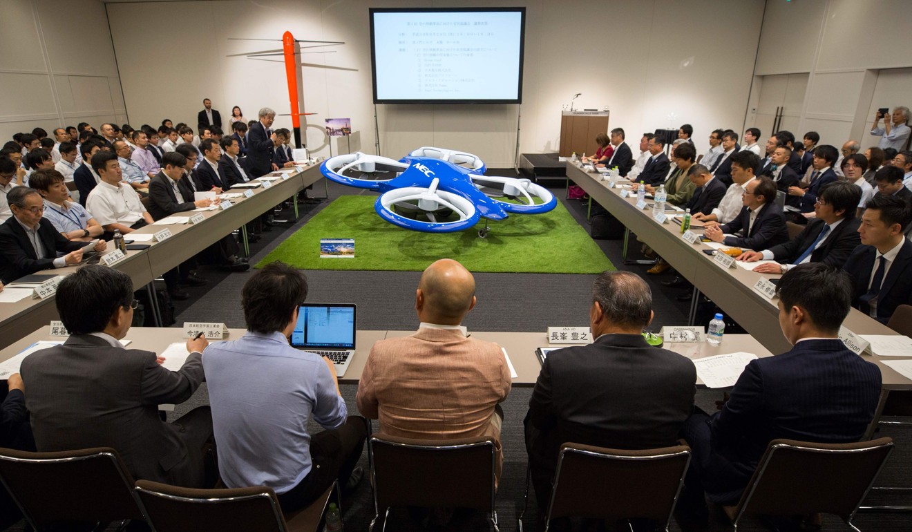 Transport-firm executives attend a government-led meeting on developing flying cars and airborne vehicles in Tokyo on August 29, 2018. Photo: AFP