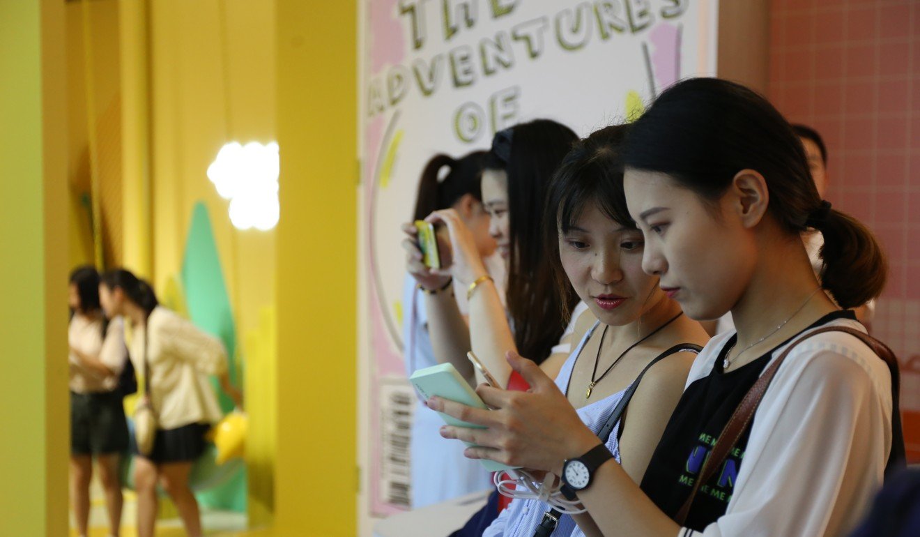 Visitors compare photos at The Egg House in Shanghai. Photo: Rachel Cheung