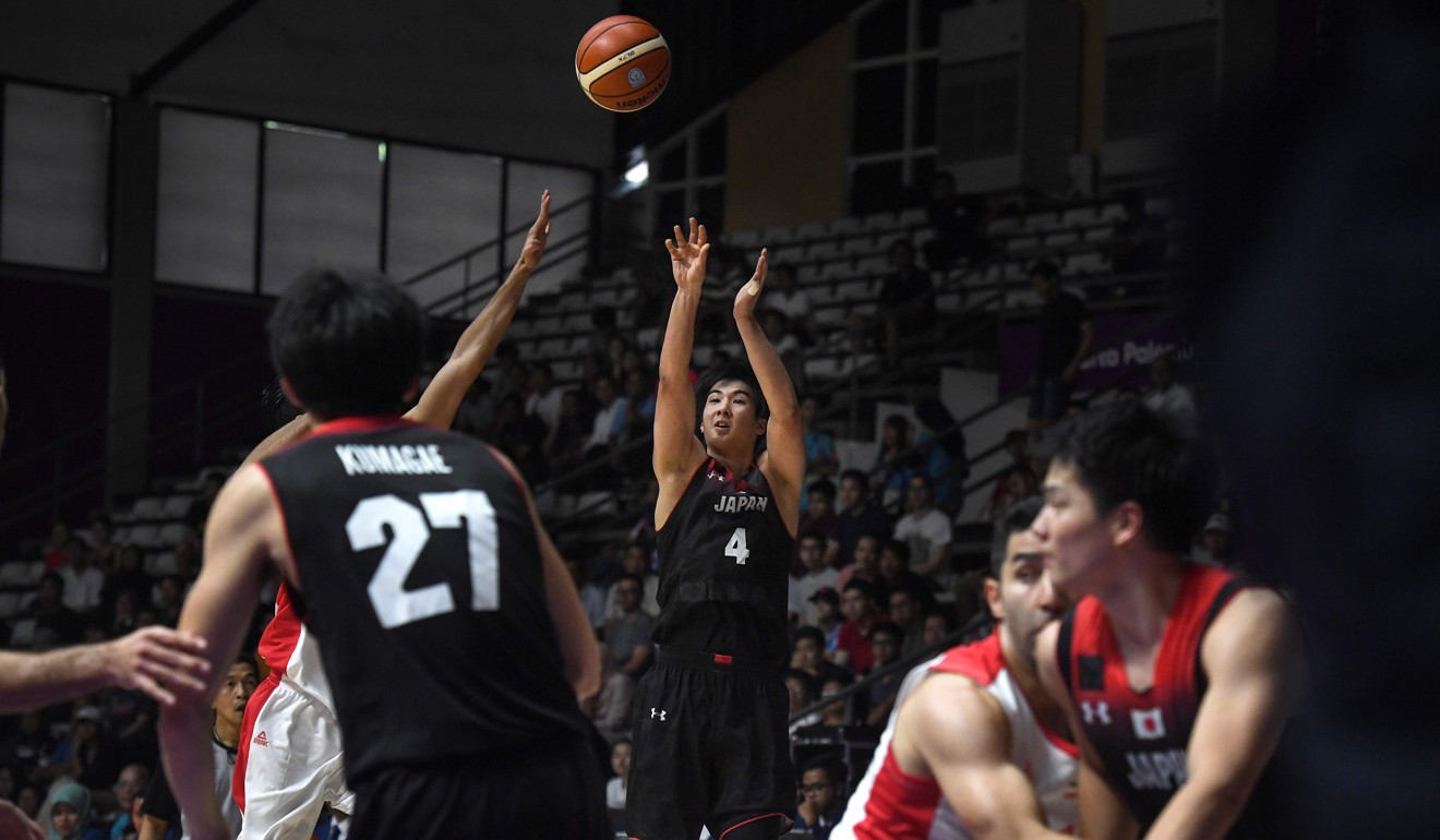Japan's Taichi Nakamura (4) shoots against Iran in the men's basketball quarter-final match. Photo: AFP