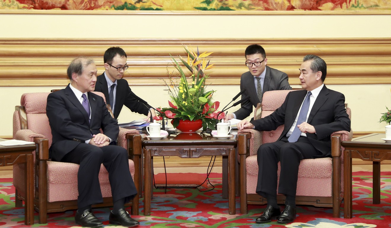 Japanese Vice Foreign Minister Takeo Akiba, at left, meets with Chinese Foreign Minister Wang Yi in Beijing, China on Wednesday. Photo: Xinhua