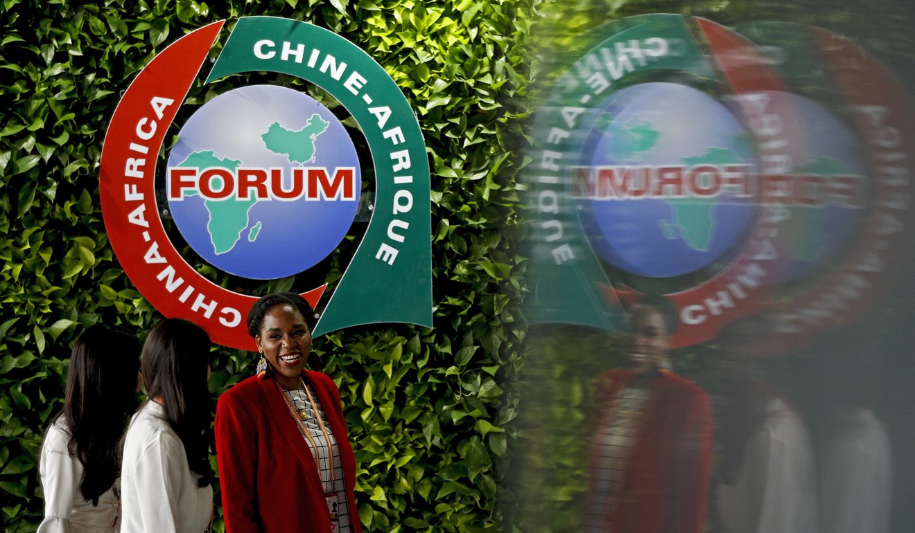 An African delegate talks with two Chinese women at the summit in Beijing. Photo: AP