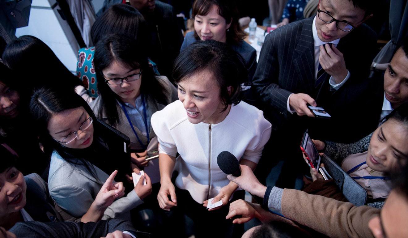 Jean Liu, President of Didi Chuxing, mobbed by reporters at the World Bank Headquarters during the 2018 IMF/World Bank spring meetings April 19, 2018 in Washington, DC. Photo: AFP