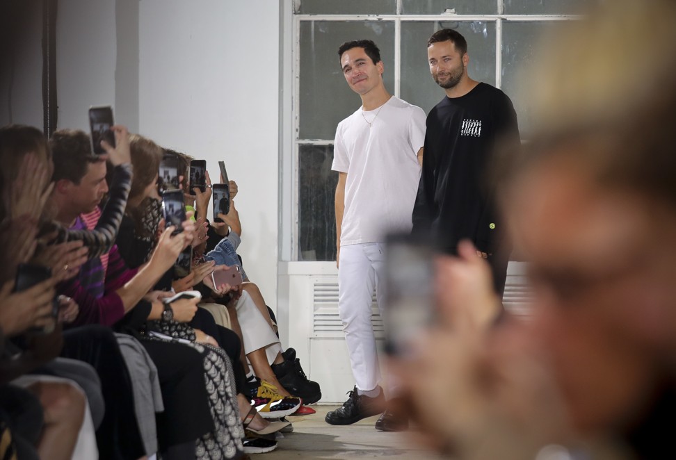 Lazaro Hernandez, left, and Jack McCollough, acknowledge applause after unveiling their latest collection for Proenza Schouler. Photo: AP