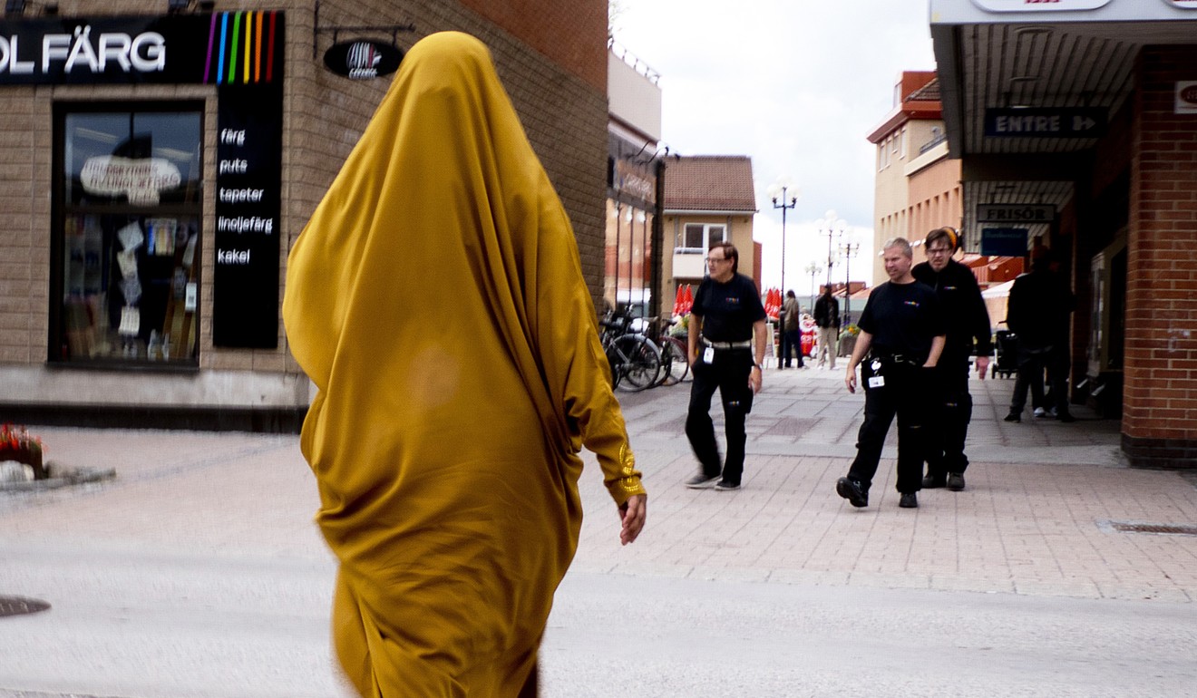 A migrant from Somalia walks through downtown Flen in Sweden. Photo: AP