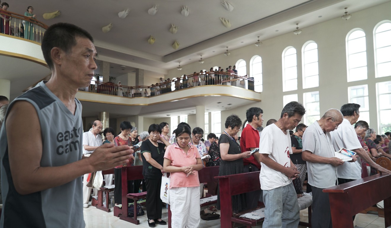 Worshippers attend a mass at the officially-sanctioned Cathedral of the Sacred Heart in Anyang. Photo: AFP