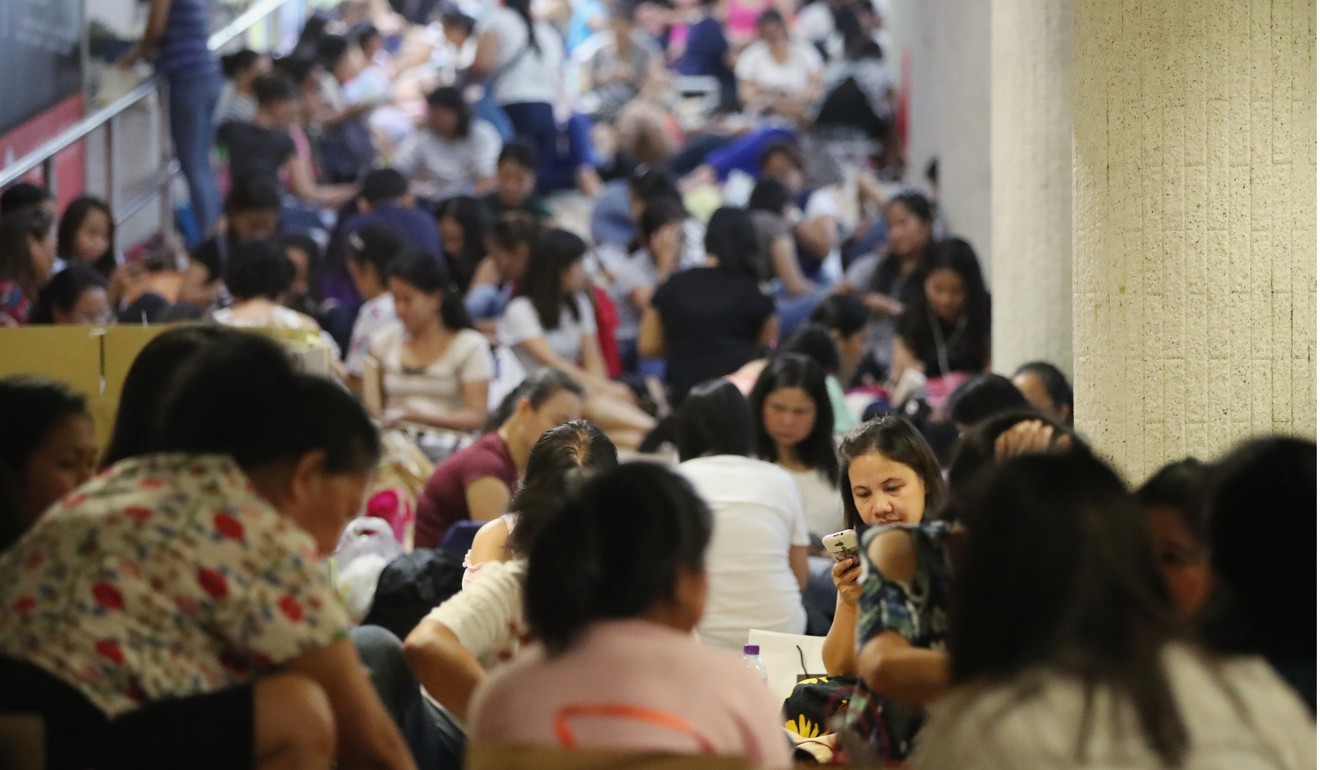 Domestic helpers gathering in Central on a public holiday. Photo: Edward Wong