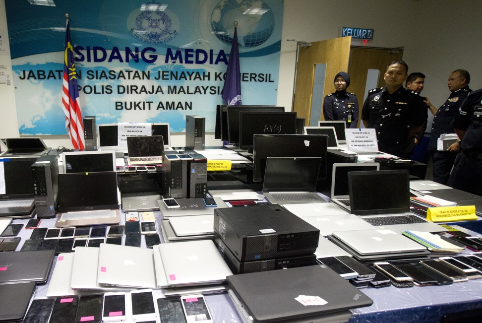 Malaysian police said officers confiscated 169 mobile phones and 114 laptops during the raid. Photo: AP
