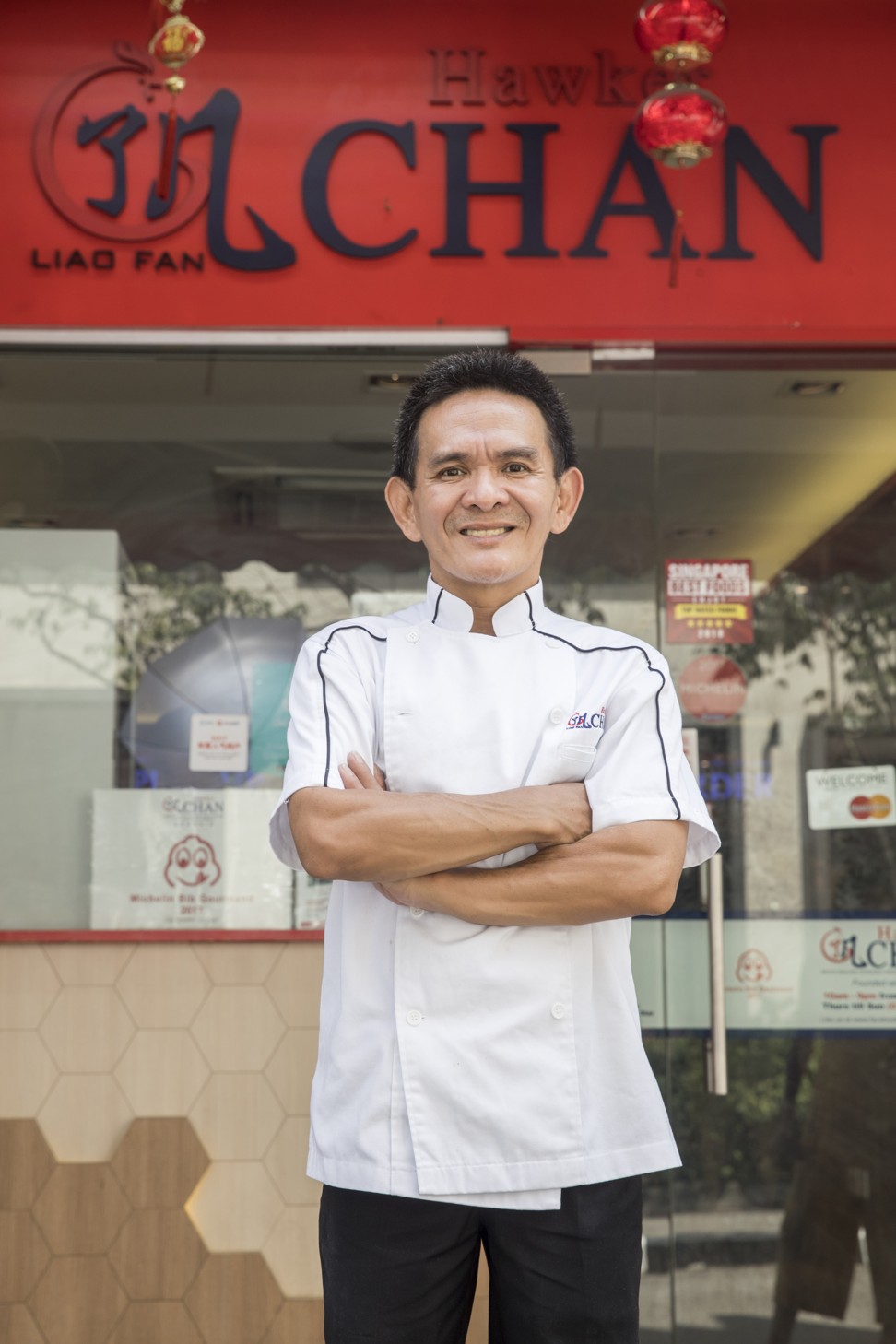 Chef Chan Hon Meng, who has earned a Michelin star for his street food, outside Liao Fan Hawker Chan restaurant in Singapore.