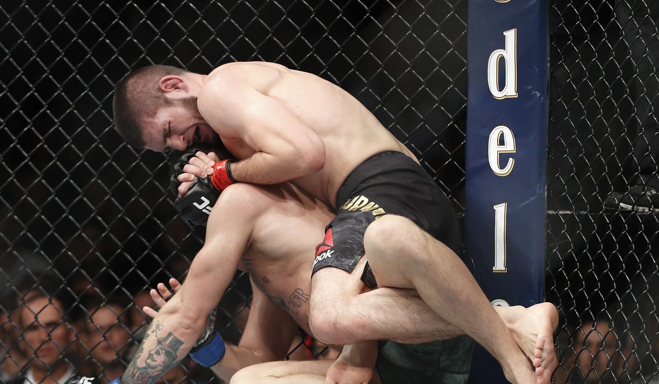 Khabib Nurmagomedov applies the rear naked choke hold that ended the fight. Photo: AP