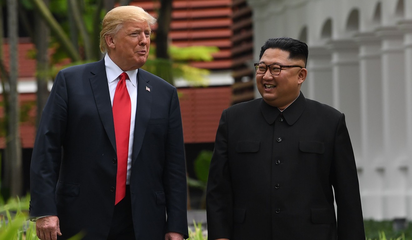 North Korea's leader Kim Jong-un walks with US President Donald Trump during a break in talks at their historic US-North Korea summit in June. Photo: AFP