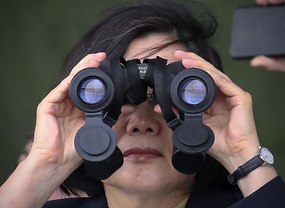 Taiwanese President Tsai Ing-wen looks through binoculars during the military exercise. Photo: EPA-EFE