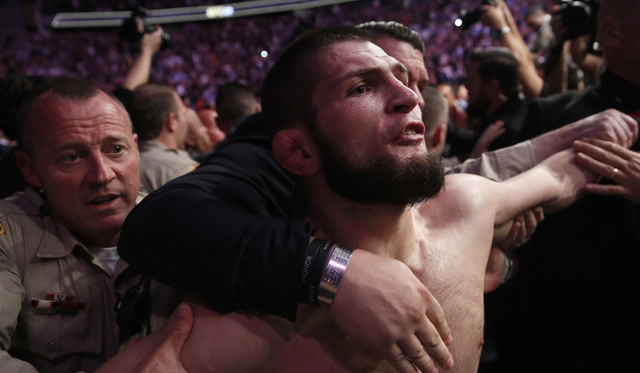 Nurmagomedov is held back outside the Octagon after fighting Conor McGregor. Photo: AP