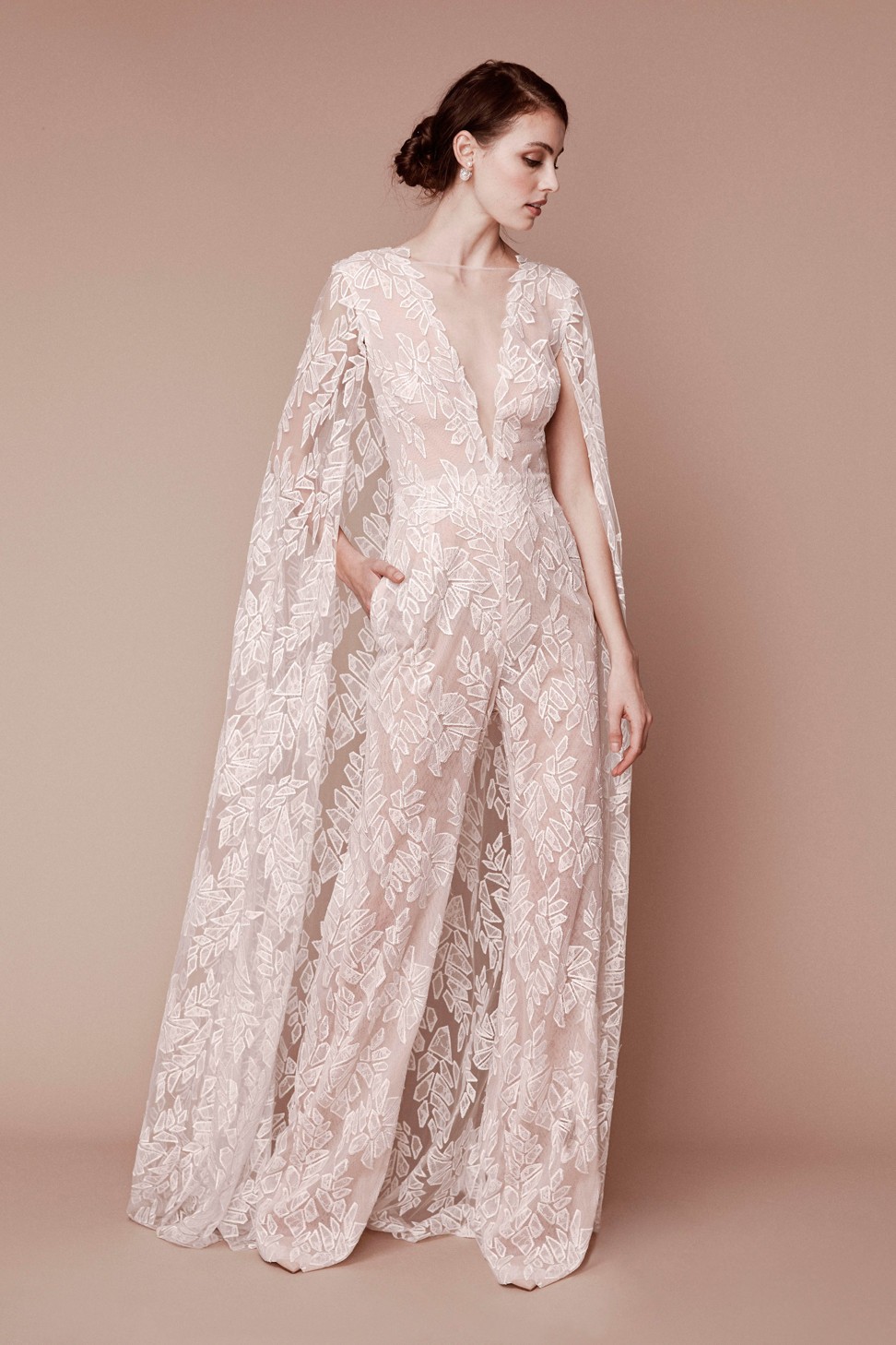 Tadashi Shoji’s 2019 collection includes an all-lace jumpsuit with a floor-length cape.