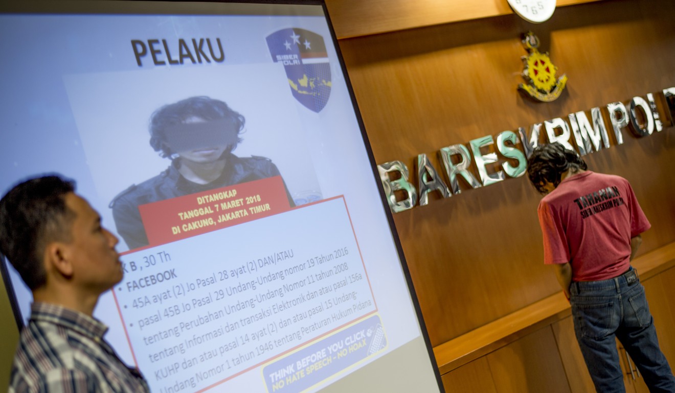 Indonesian cybercrime police display a photo of a suspect accused of spreading fake news. Photo AFP
