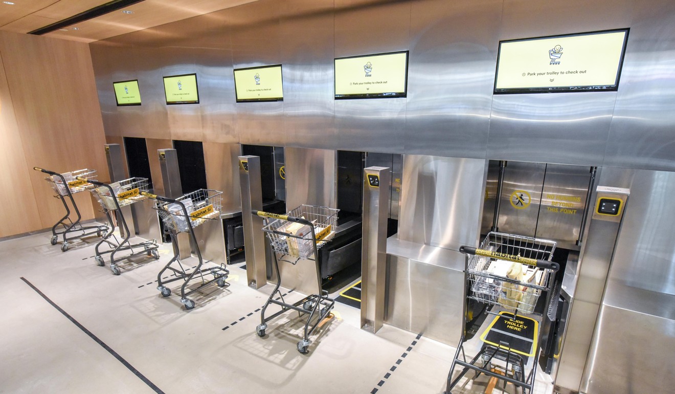 Trolleys filled with groceries disappear behind metal doors to be packed at Habitat. Photo: Handout