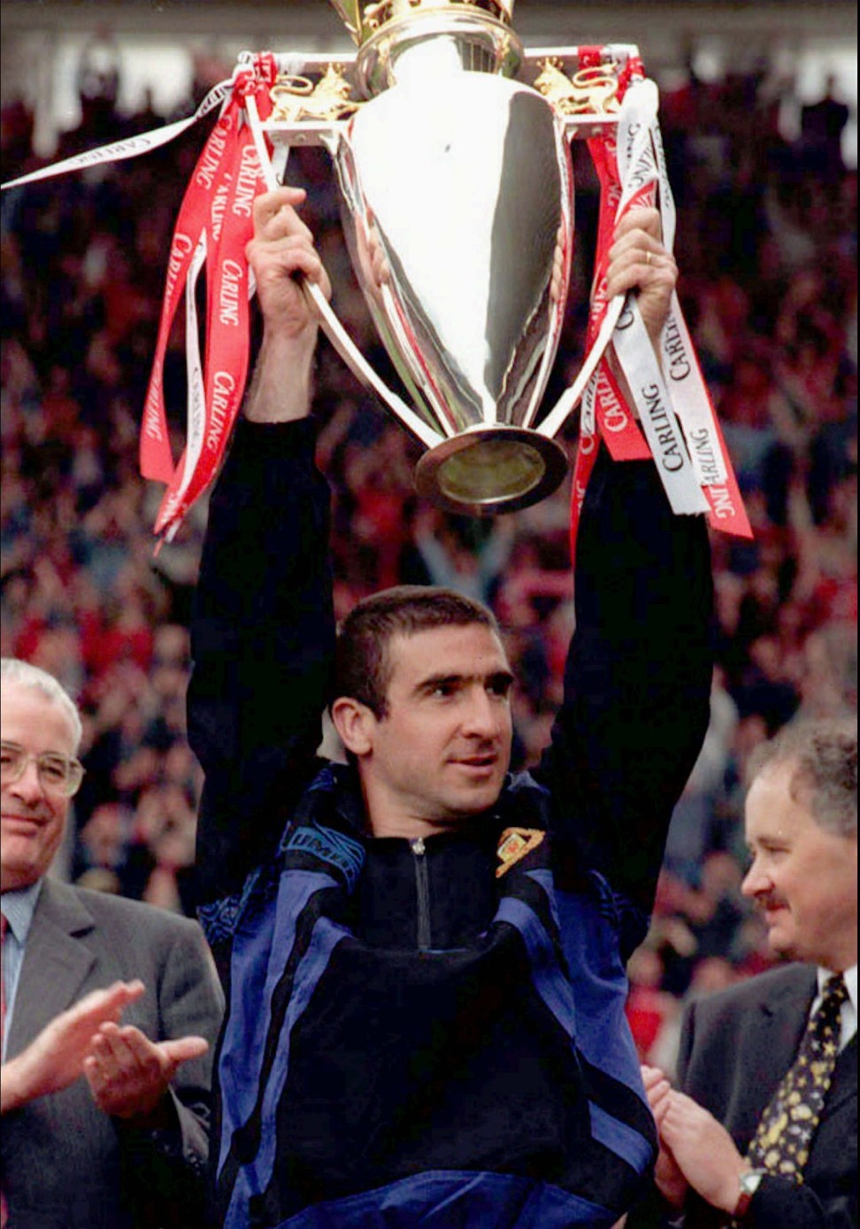 Eric Cantona holds the English Premiership Trophy aloft after Manchester United took the title by beating Middlesbrough 3-0 at the Riverside Stadium in Middlesbrough on May 5, 1996. Photo: AP