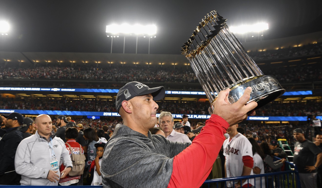 Manager Alex Cora celebrates with the World Series trophy. Photo: AFP