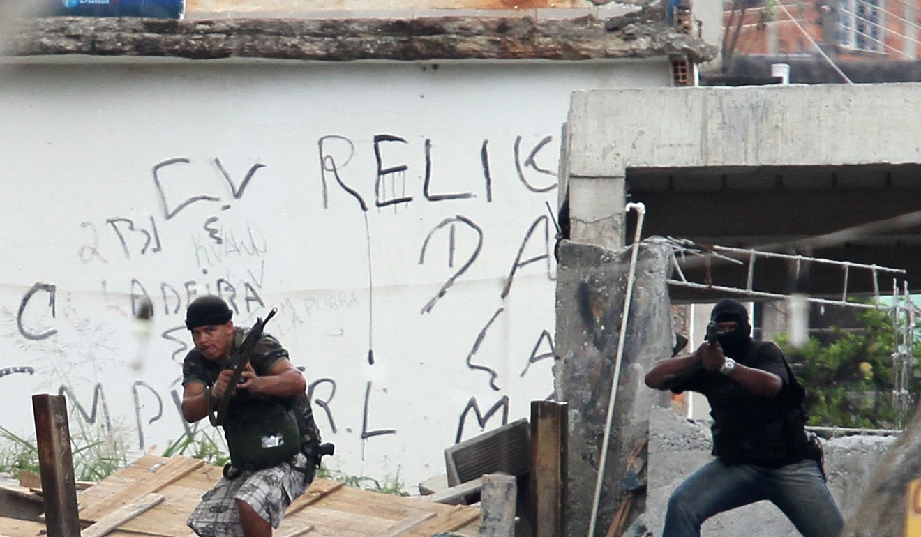 Armed suspected drug gang members take positions during an operation at Grota slum in Rio de Janeiro. File photo: Reuters