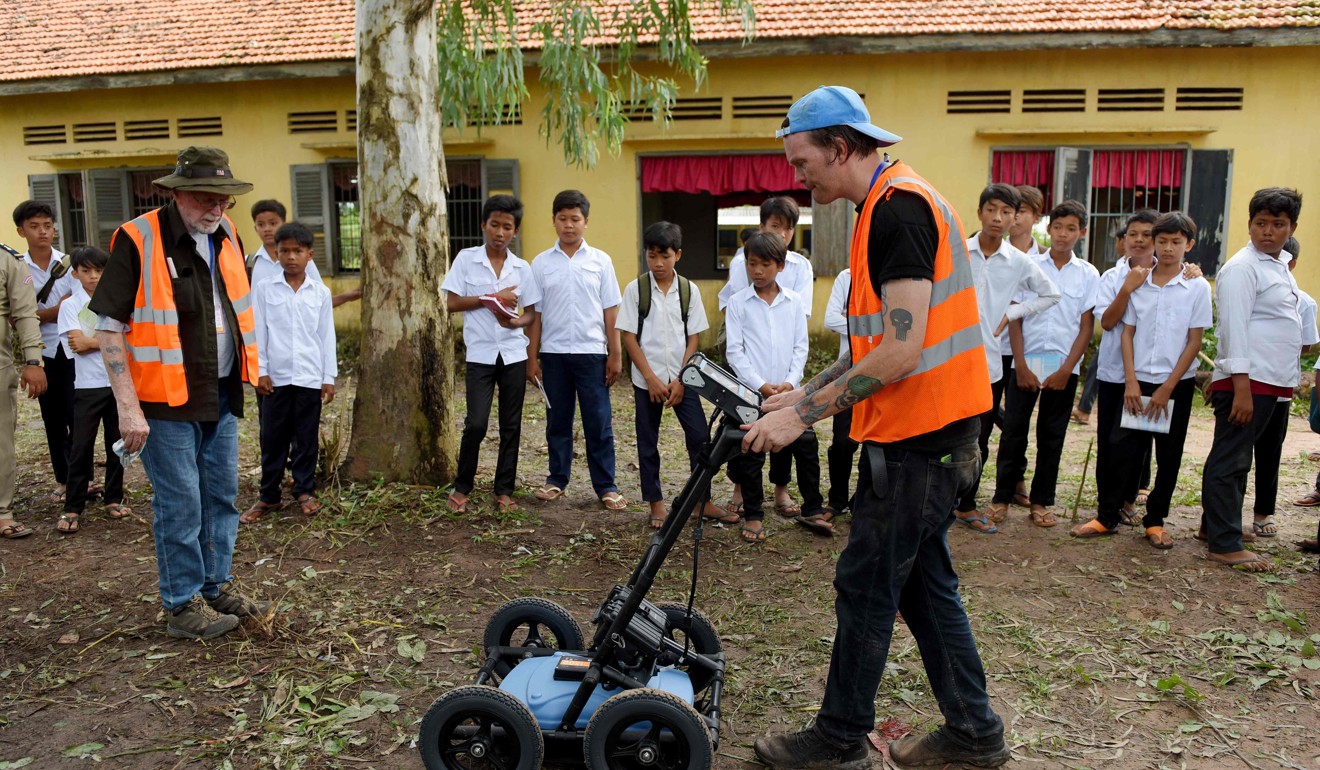 An expert from SparrowHawk Far East company uses ground-penetrating radar to search for mass graves at a school compound in Prey Veng province, Cambodia. Photo: AFP
